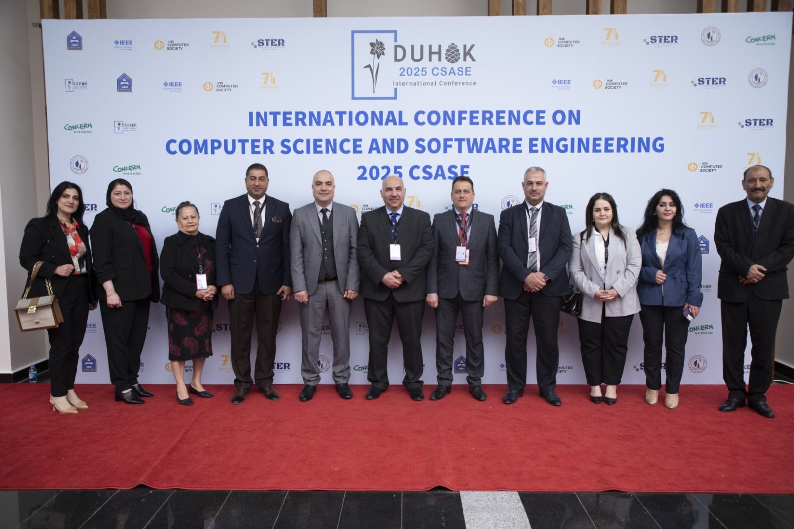 Group photo of organisers and guests in front of the CSASE 2025 / IEEE backdrop