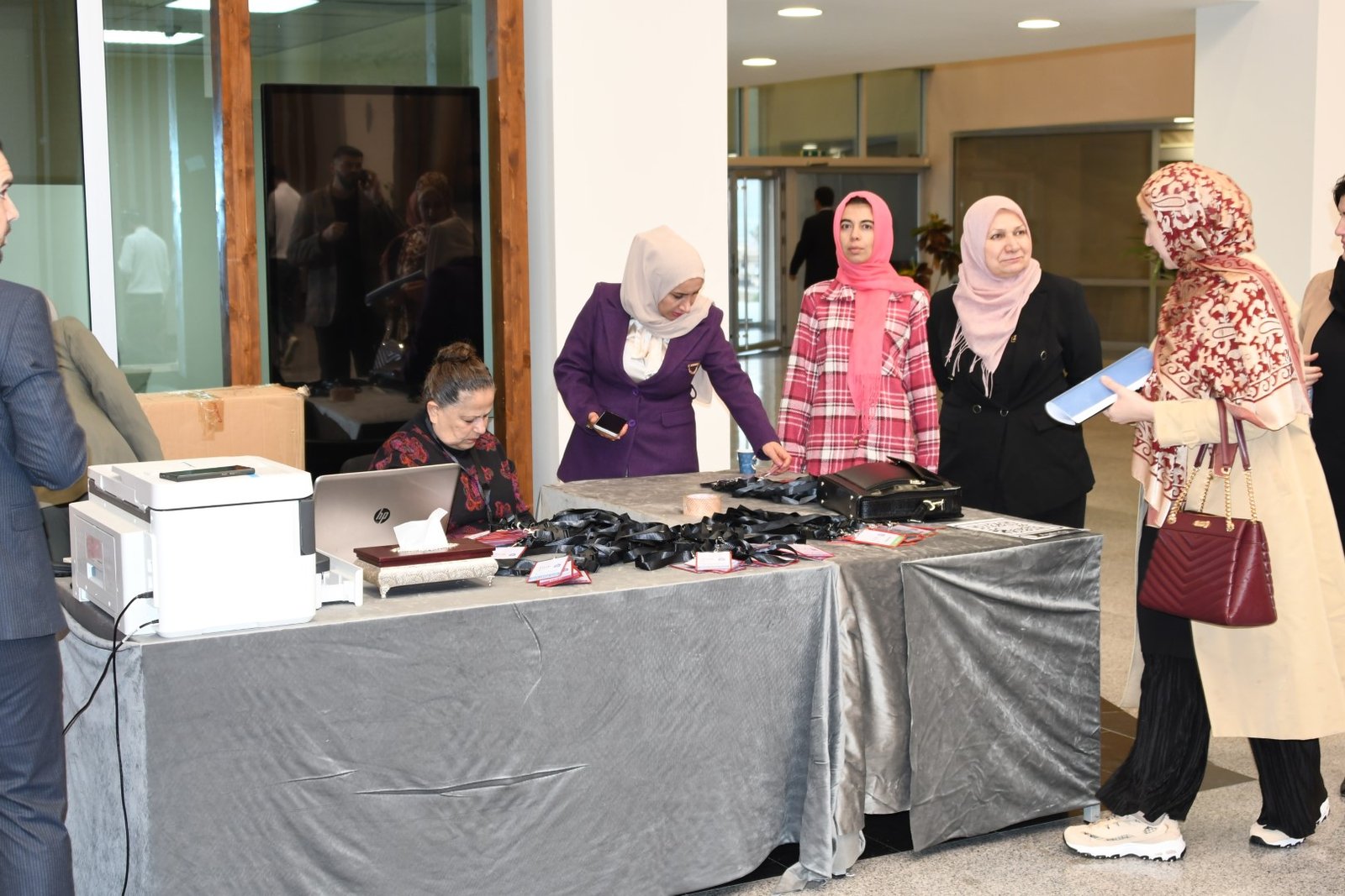 Registration desk with attendees collecting conference materials