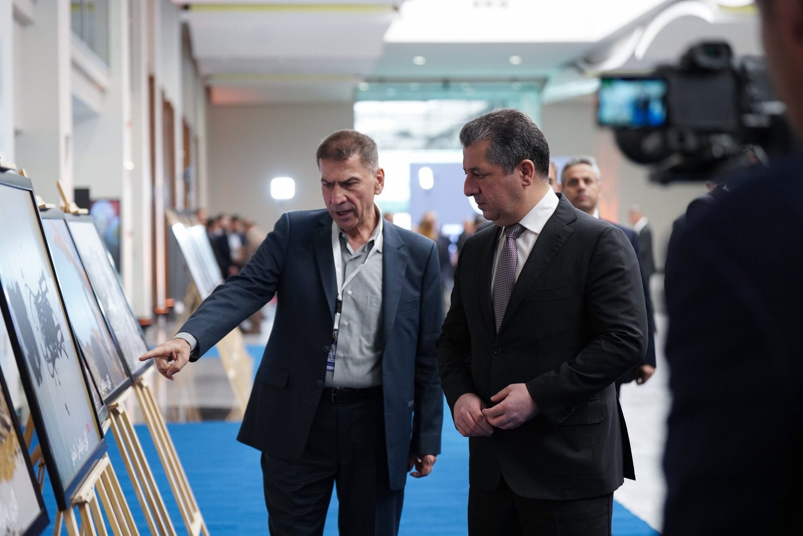 Day 1: guests viewing the photographic exhibition panels